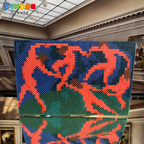 Artistic display of red and blue geometric figures in a gallery setting